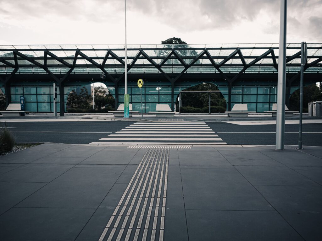 Soft-focus empty urban intersection in daylight, representing a motorcycle and Metro bus left-turn claims guide without showing a collision.